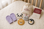 Little Reachers mitten and lightweight play pieces arranged in a flat lay